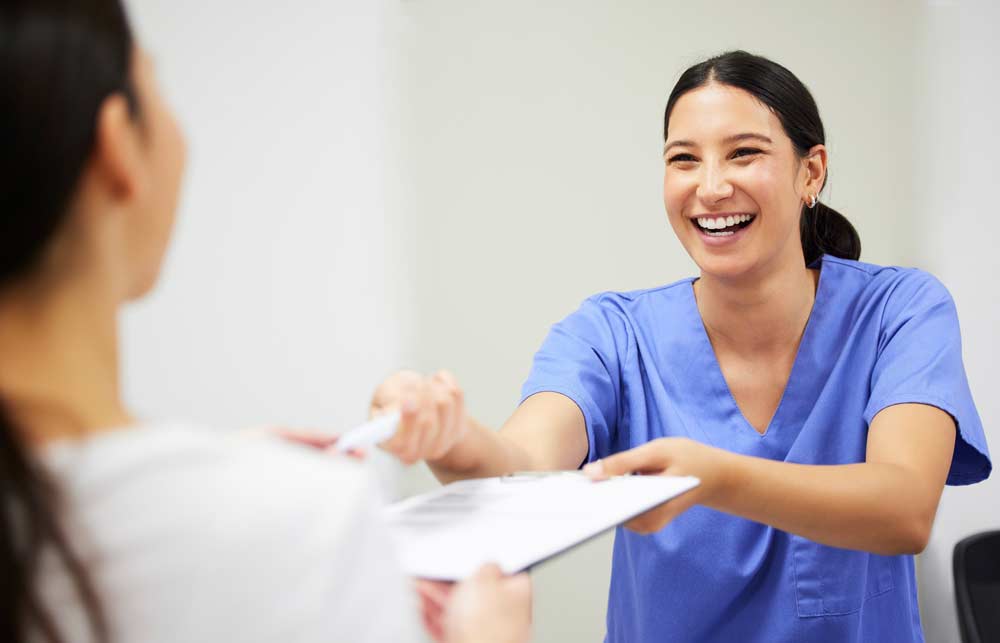 A patient receiving forms for an appointment
